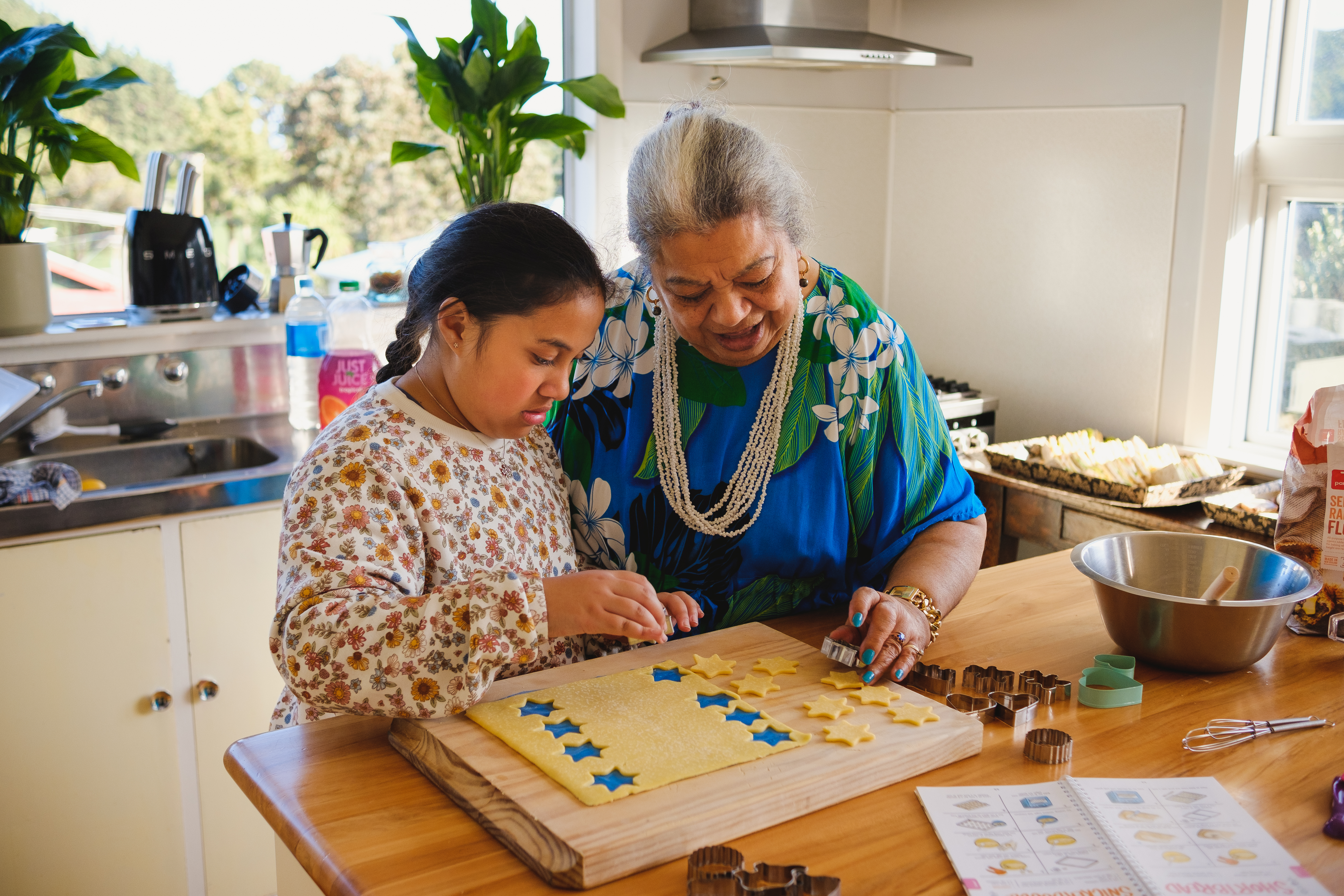 Kuia and mokopuna baking biscuits